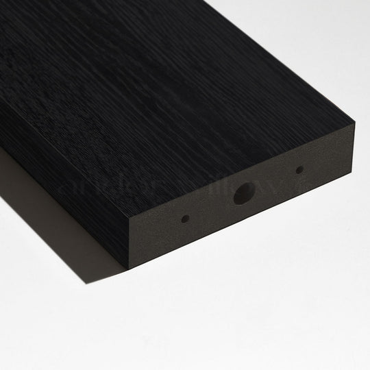 A pre-drilled wood slat for a room divider laying on white studio background