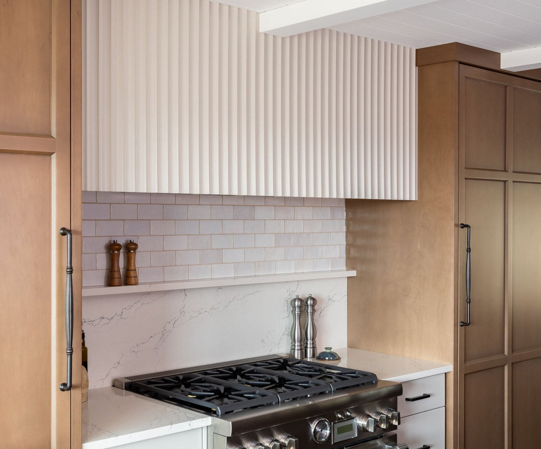 modern american kitchen with stove and fluted white wall panelling above range