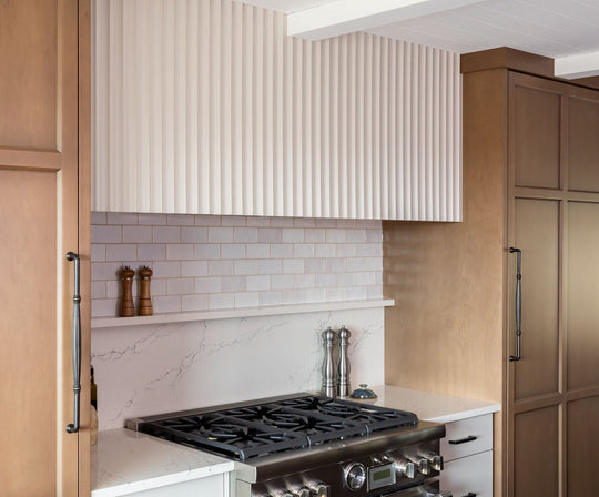 modern american kitchen with stove and fluted white wall panelling above range
