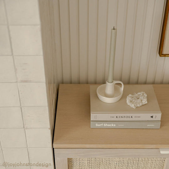 closeup image of white oak credenza with slatted wall paneling behind