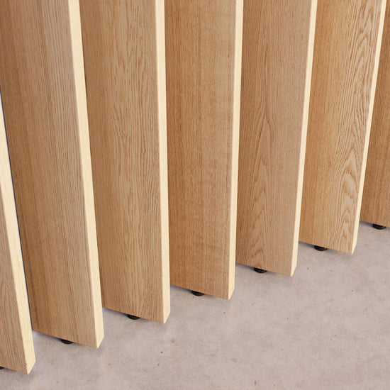 closeup image of vertical white oak slats that rotate as part of a wood slat partition system