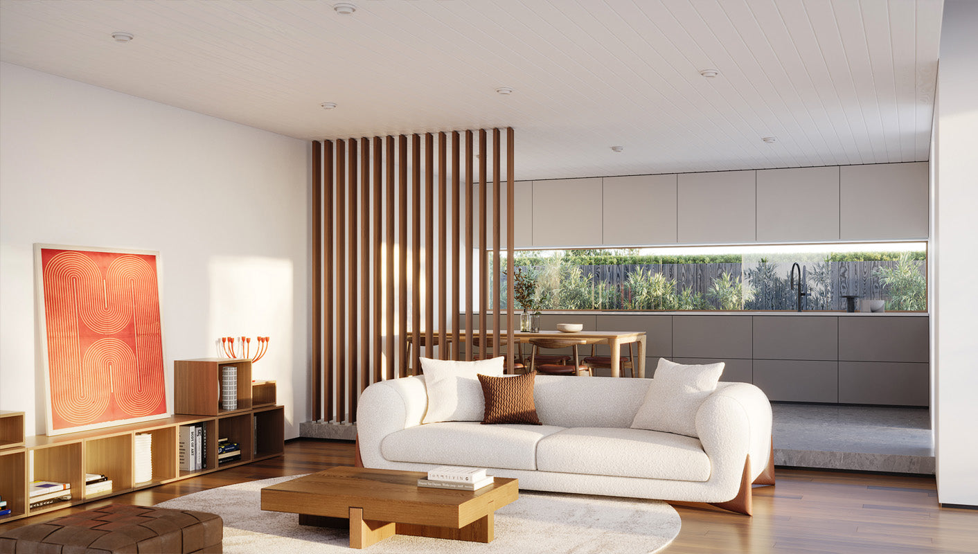 cozy living room with a gray sectional sofa, wood slat divider, and large windows allowing natural light