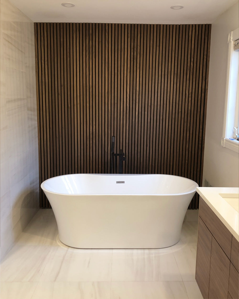 wood slat accent wall in a bathroom with a bathtub