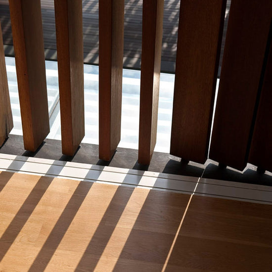 closeup image of rotating wood slats in vertical wood slat room divider