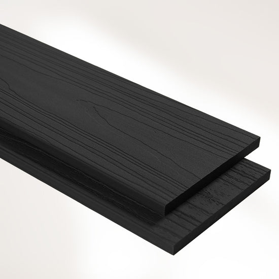 closeup image of black wood-look composite fascia boards on white background