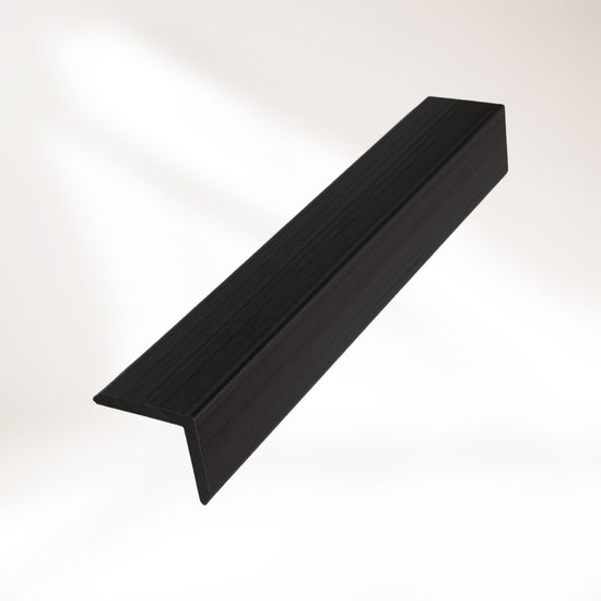 closeup image of black composite trim piece on white background