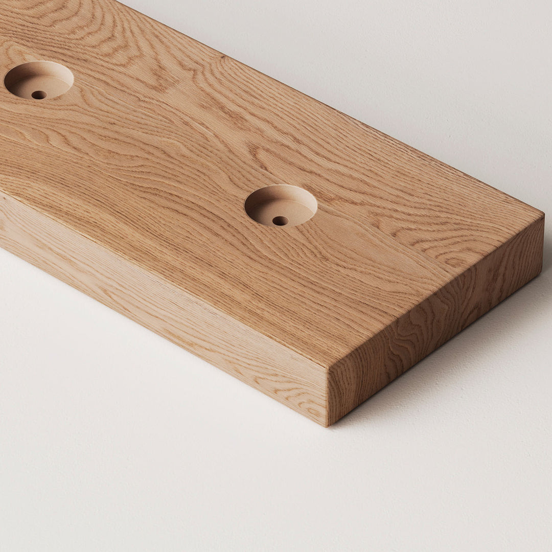 closeup image of wood slat divider floor base with pre-drilled holes in oak