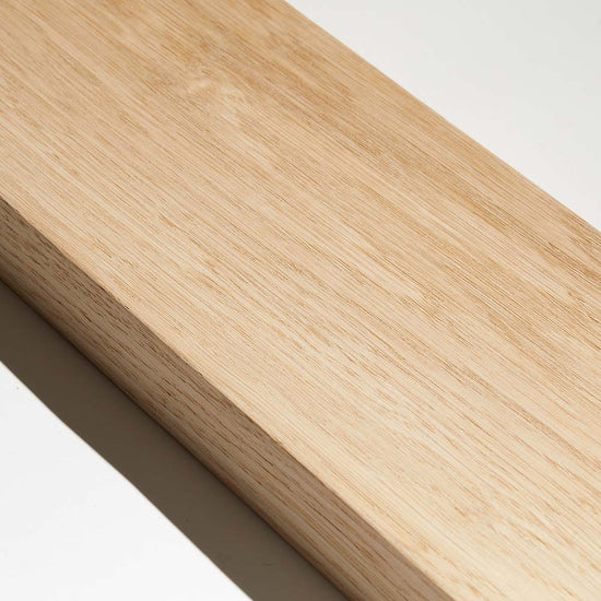 sample of oak wood slat room divider against white background