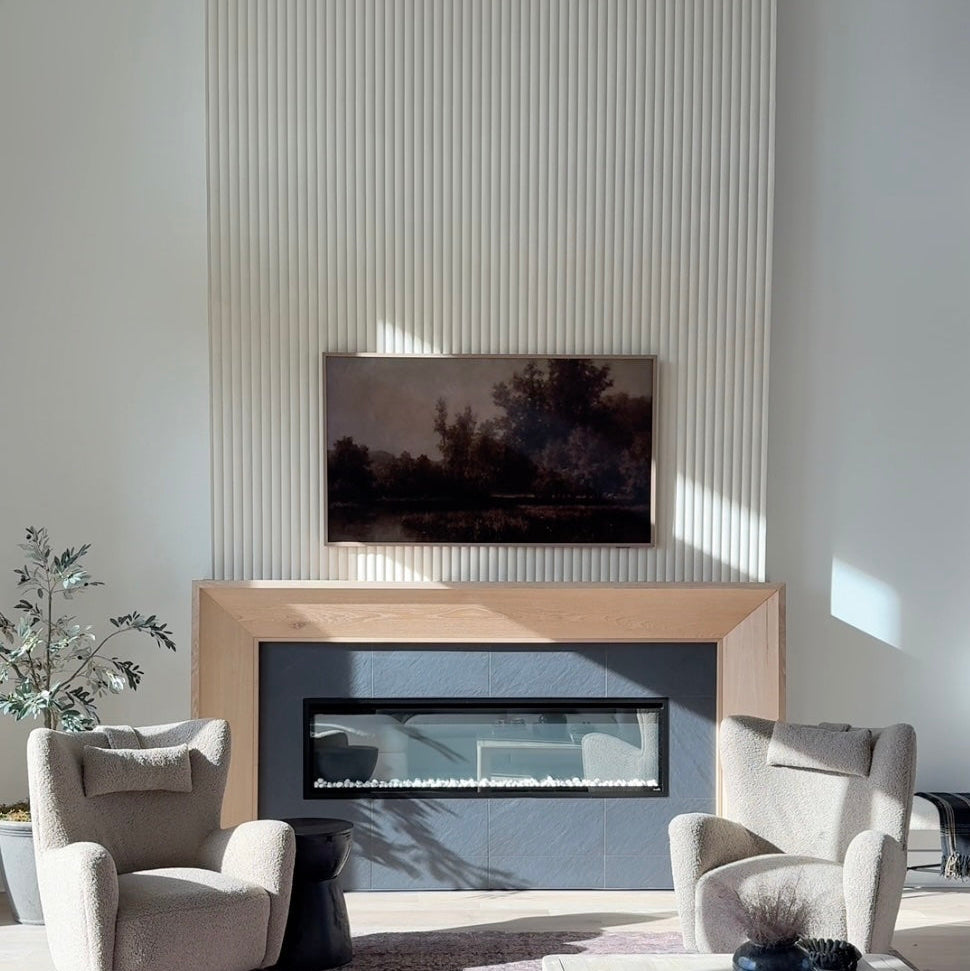 Modern living room with a fireplace, television, and a fluted vertical accent wall.