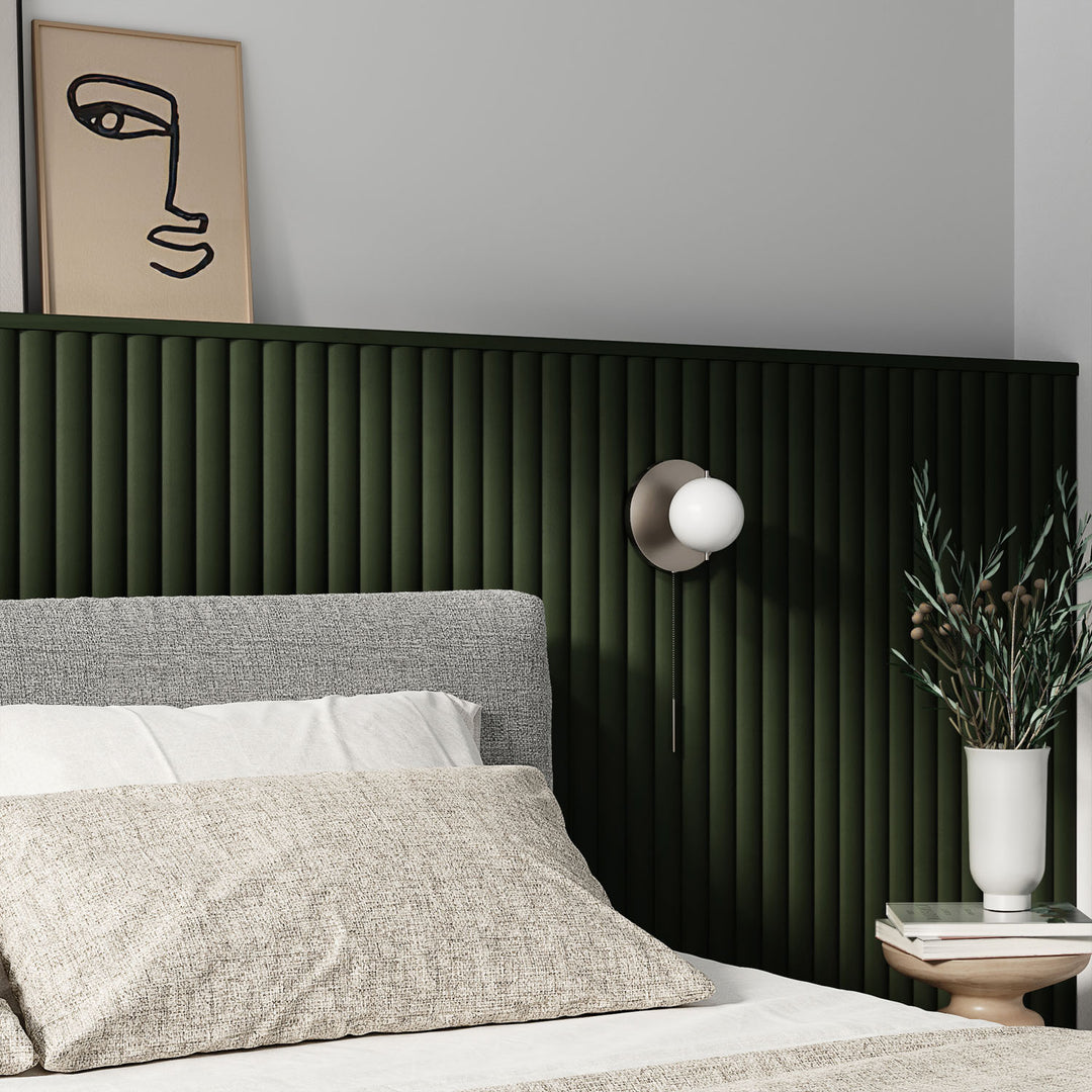 organic aesthetic bedroom with green fluted wall paneling behind bed