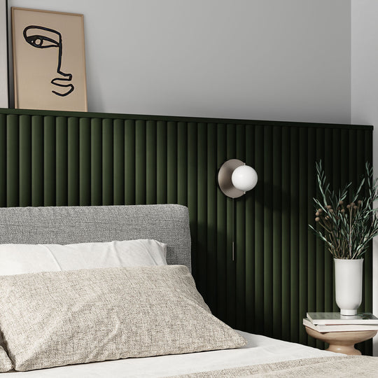 organic aesthetic bedroom with green fluted wall paneling behind bed