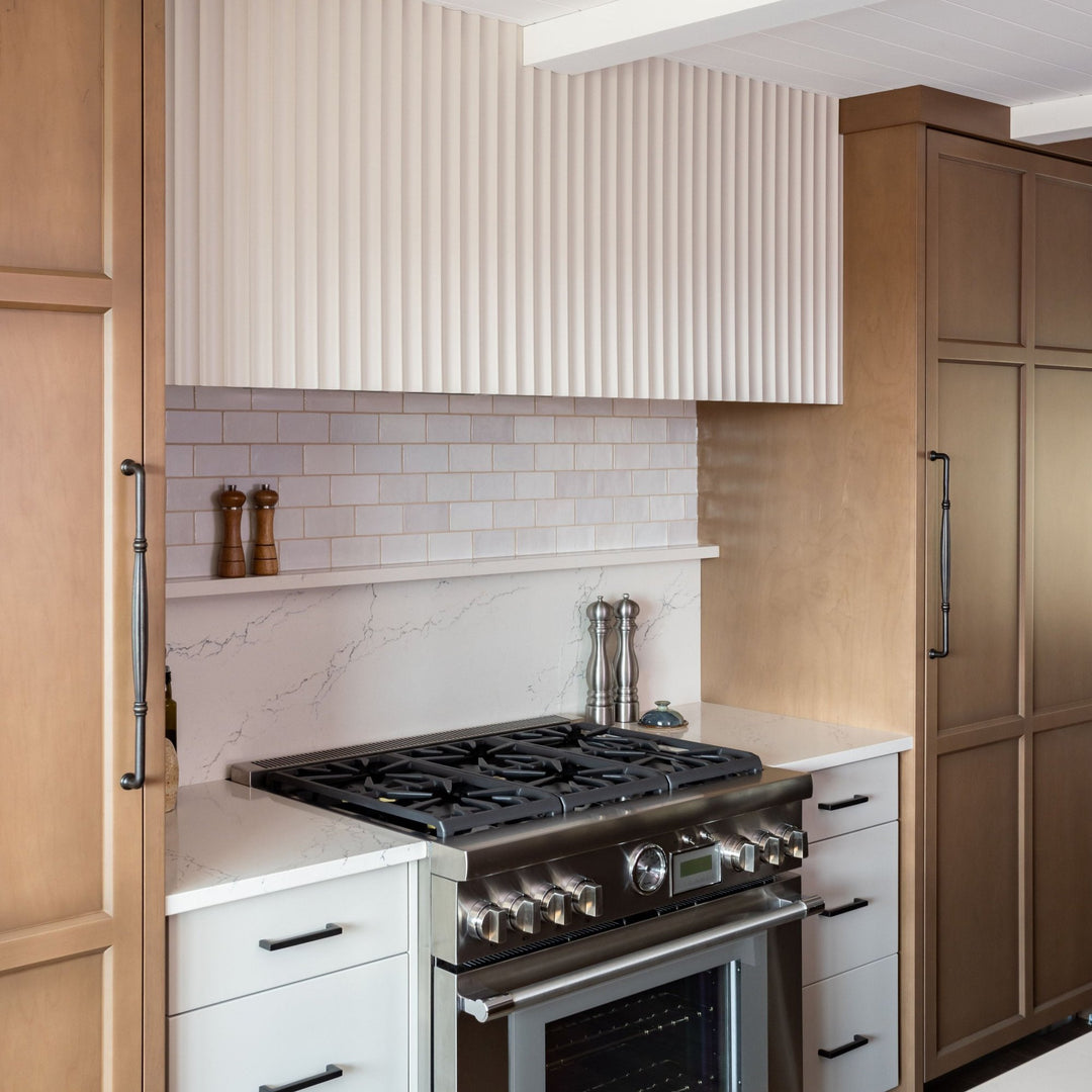 modern american kitchen with stove and fluted white wall panelling above range