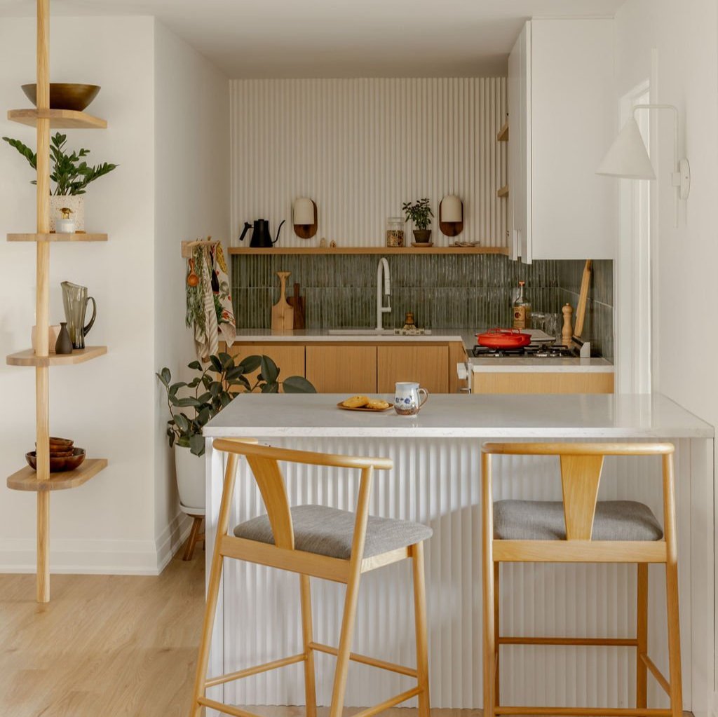 modern kitchen renovation with green tile backsplash and fluted panel dining bar island