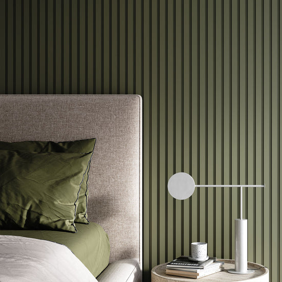 minimalist bedroom with green painted slatted accent wall behind bed