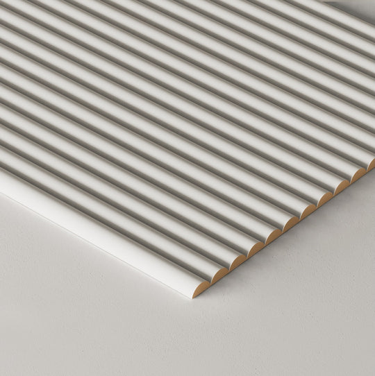 A close-up of a paintable tambour panel shown at an angle on a light gray surface.