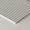 A close-up of a paintable tambour panel shown at an angle on a light gray surface.