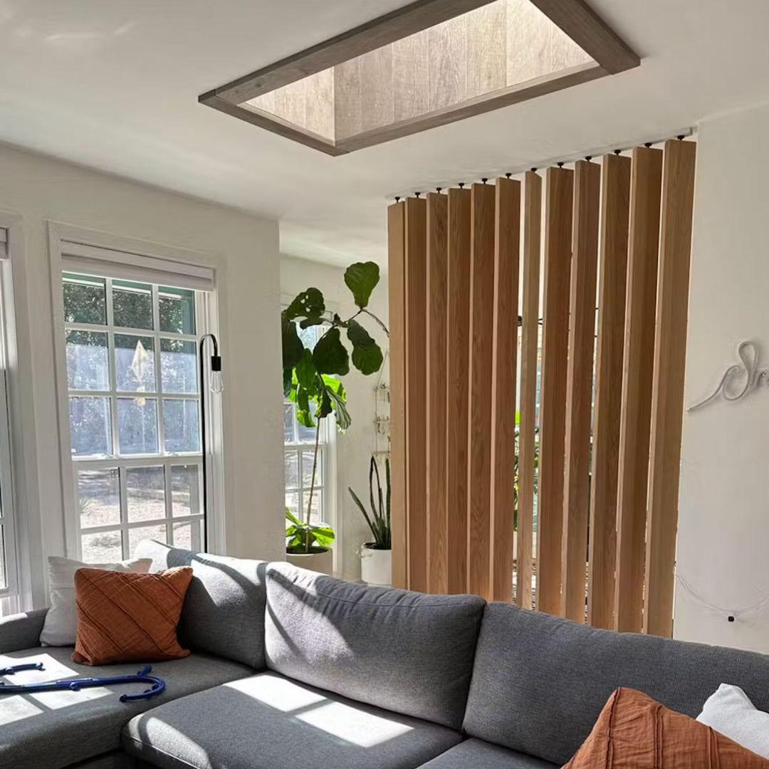 white oak floor to ceiling room divider in sunny living room