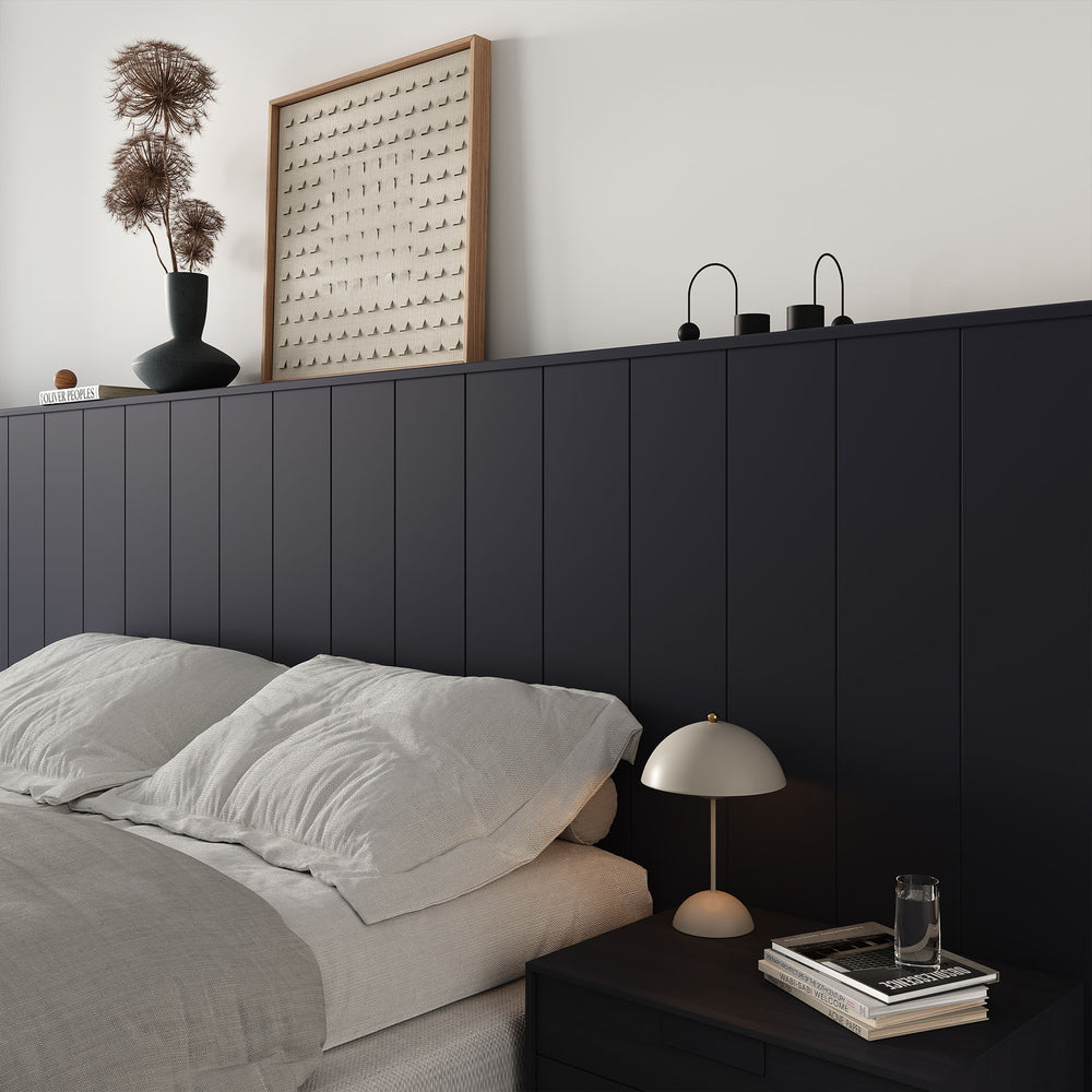 minimalist bedroom with v-groove panelled half-wall behind bed