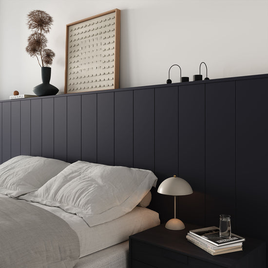 minimalist bedroom with v-groove panelled half-wall behind bed