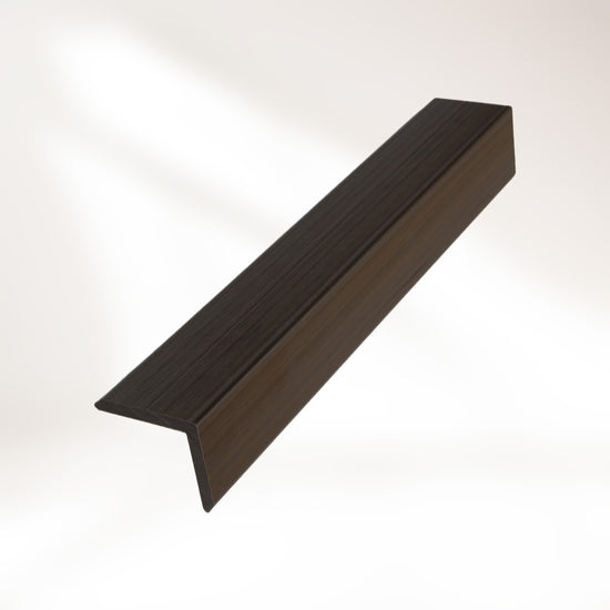 closeup image of walnut composite trim piece on white background