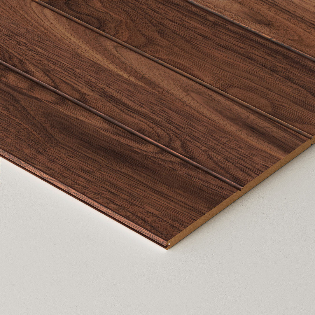 Close-up of walnut wooden wall planks on a white background
