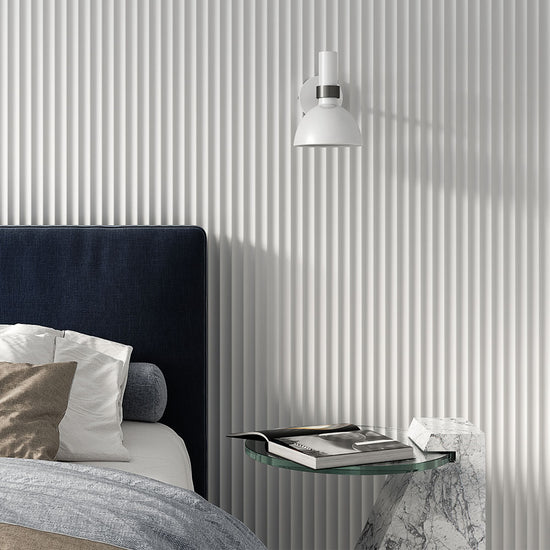 minimalist bedroom with white fluted wall panelling behind bed headboard