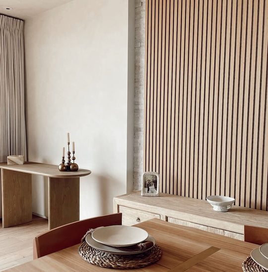 Dining room with wooden furniture and white oak slat paneling
