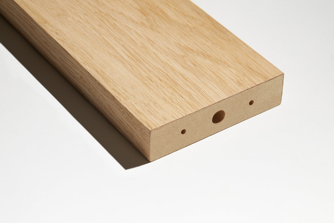 closeup image of one mdf slat wrapped in a real oak veneer with pre-drilled holes