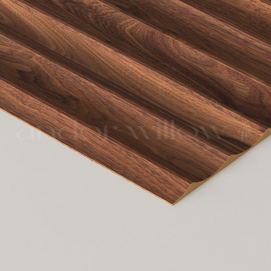 close-up studio image of wide fluted walnut wall panelling on white background