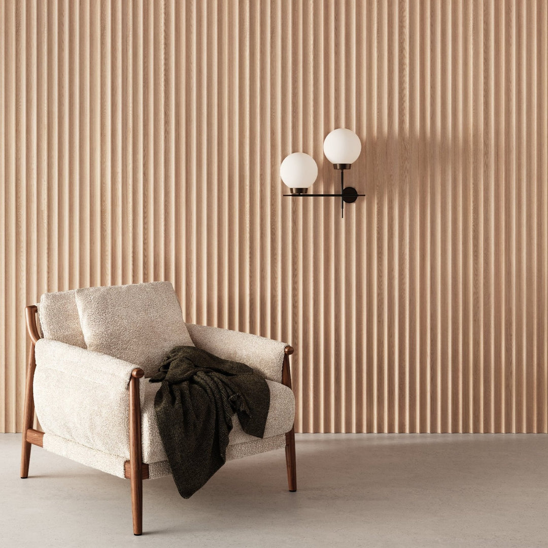 oak fluted wall panels behind Scandinavian chair and concrete floor