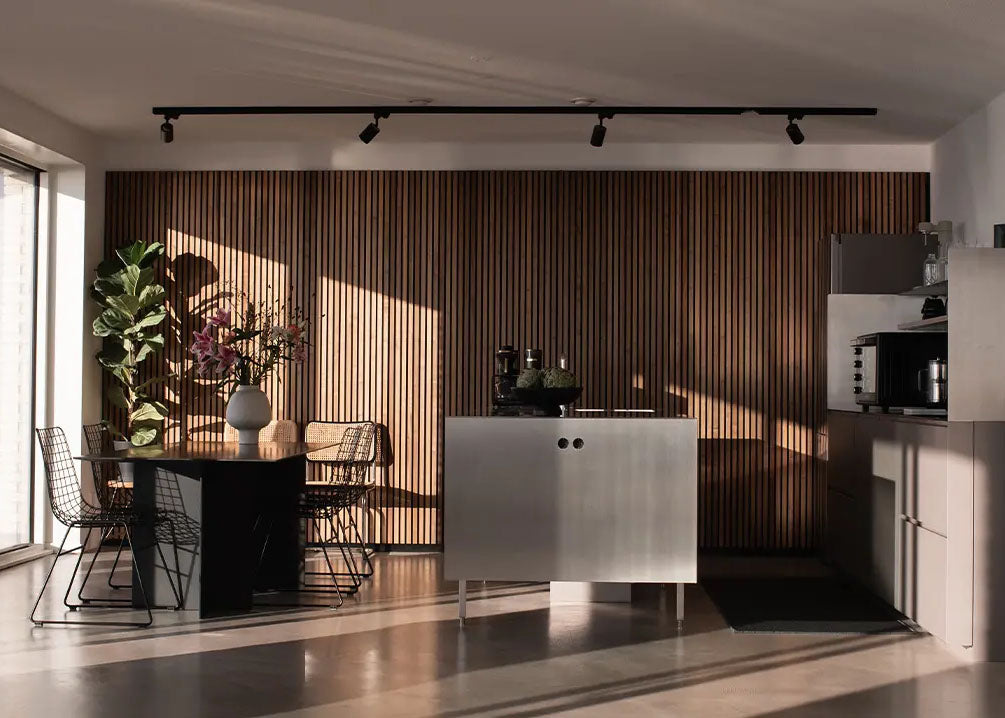 sunny midcentury modern apartment kitchen with concrete floors and a vertical wood slat accent wall