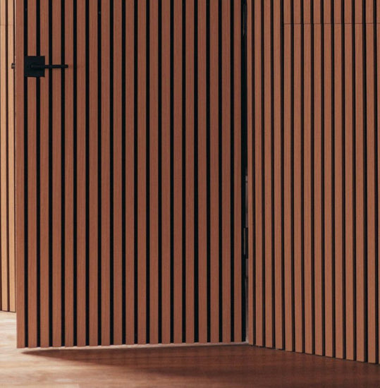hidden interior door covered in oak wood slat wall panels
